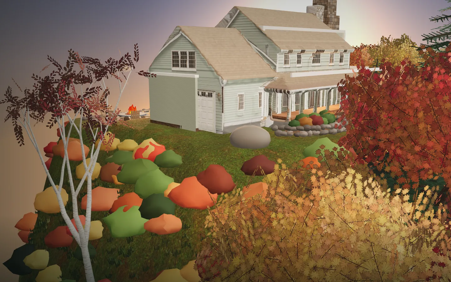 The farmhouse's garage side and wraparound porch, with a stone garden bed and pumpkins on the lawn