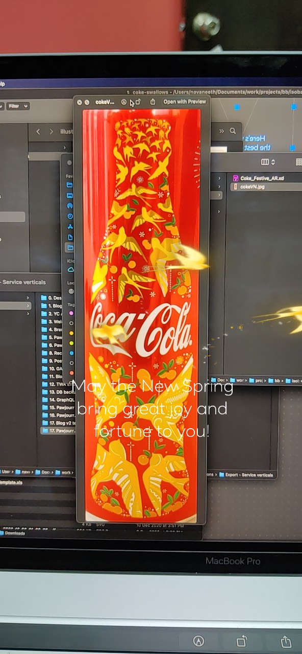 Portrait development capture of festive Coca-Cola packaging with a golden bird at the side.