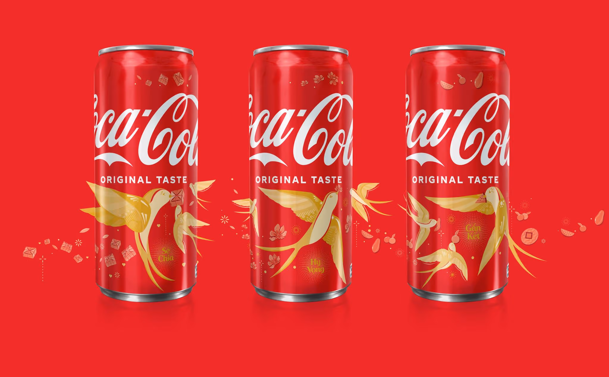 Three red Coca-Cola cans with golden swallow illustrations against a red background.